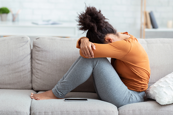Young woman depressed on sofa