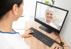 Old Caucasian lady using telehealth for doctors visit