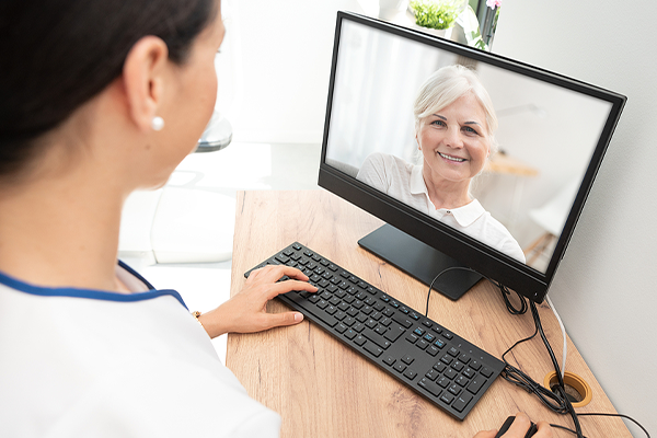 Old Caucasian lady using telehealth for doctors visit