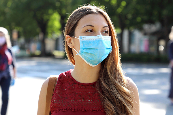 Woman wearing mask outside and socially distanced